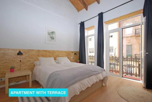 a bedroom with a bed and a large window at Apartments Valencia, Cabañal in Valencia
