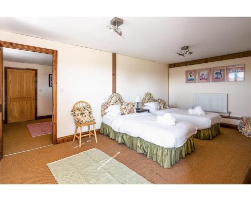מיטה או מיטות בחדר ב-Huish Lodge