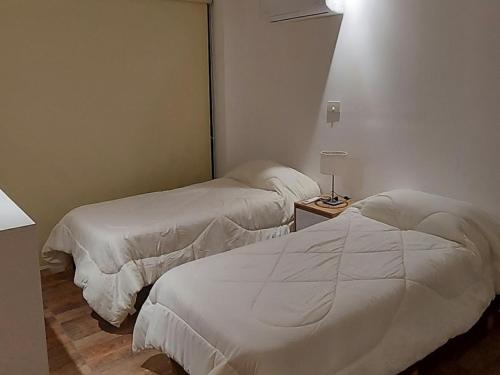 A bed or beds in a room at Departamento Ezeiza
