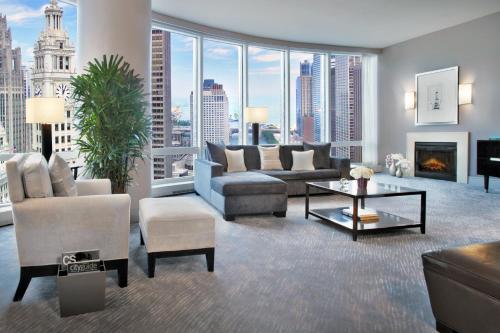 a living room filled with furniture and a large window at Trump International Hotel & Tower Chicago in Chicago