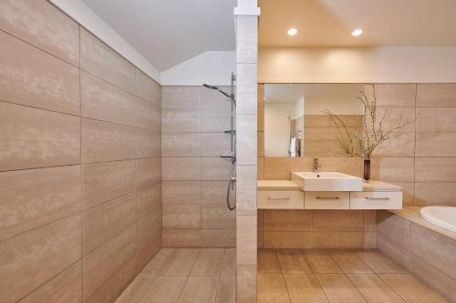 a bathroom with a sink and a mirror at Parehua Resort in Martinborough 