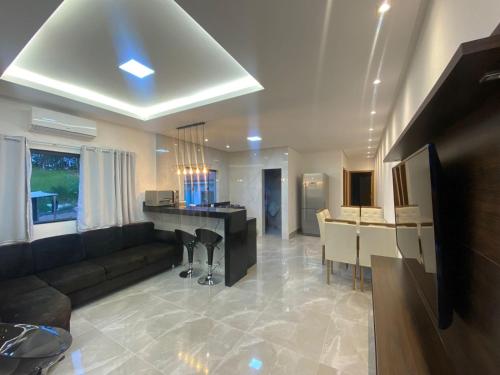 a large living room with a couch and a desk at Residencial Santos in Capitólio
