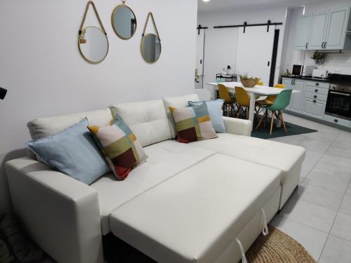 a white couch with pillows in a living room at Riviera Beach AL in Praia da Vitória