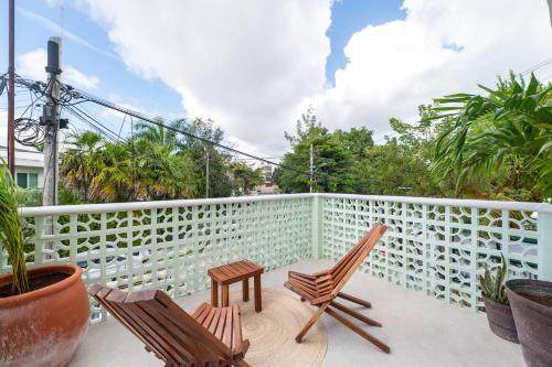 two chairs on the balcony of a house at Casa Ikal in Cancún