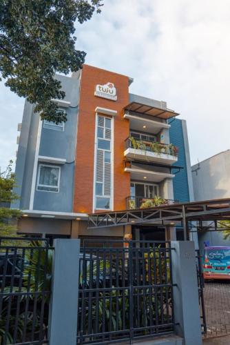a building with a fence in front of it at Tuju WK Homes Syariah in Jakarta