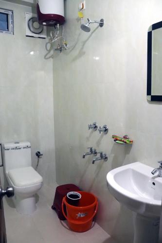 a bathroom with a toilet and a sink at THE HOTEL MILLENNIUM in Imphal