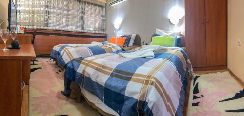 a bedroom with two beds with towels on them at Hotel Square Macedonia in Skopje