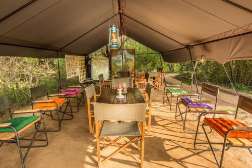 a group of tables and chairs under a tent at Big Game - Wilpattu by Eco Team in Wilpattu