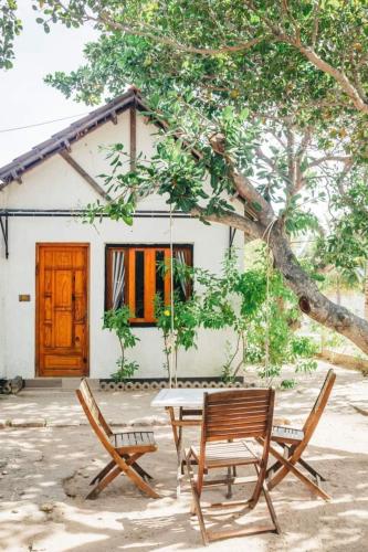 a table and chairs in front of a house at Villa Đảo Hoa Vàng Cam Ranh - Venuestay in Cam Ranh