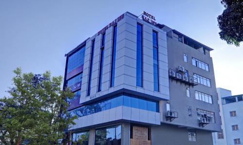 a tall building with blue windows on the side of it at Treebo Trend Raj Inn Lalpur in Rānchī
