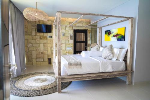 a bedroom with a canopy bed with a mirror at Theodor at Labuan Bajo in Labuan Bajo