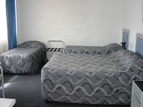 Tempat tidur dalam kamar di Dalby Manor Motor Inn