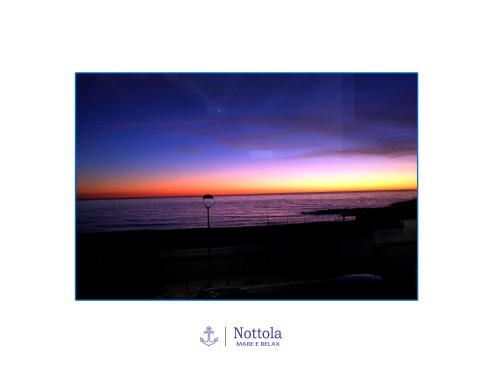 a view of a sunset from a balcony at Nottola B&B in Ladispoli