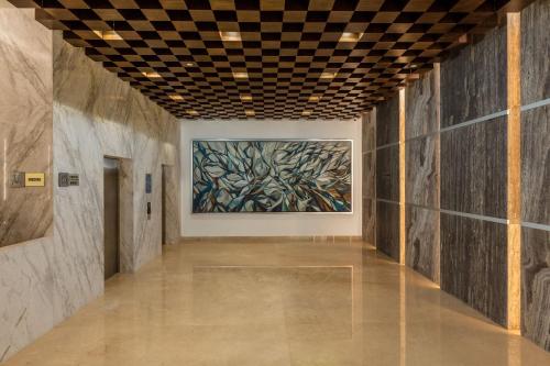 a hallway of an art museum with a painting on the wall at Camino Real Mérida in Mérida