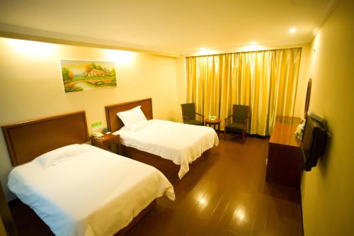 a hotel room with two beds and a window at GreenTree Inn Shanghai Meilan Lake Hutai Road Express Hotel in Baoshan