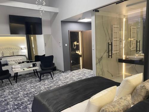 ルブリンにあるHotel Korona Spa & Wellnessのベッドルーム(大型ベッド1台付)、バスルームが備わります。