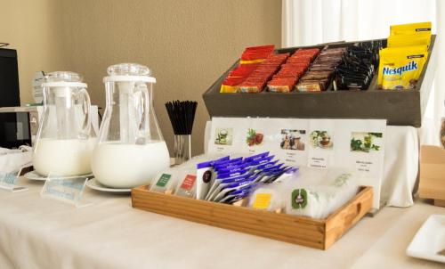 a table with two containers of milk and a box of food at Aparthotel Villas La Manga in La Manga del Mar Menor