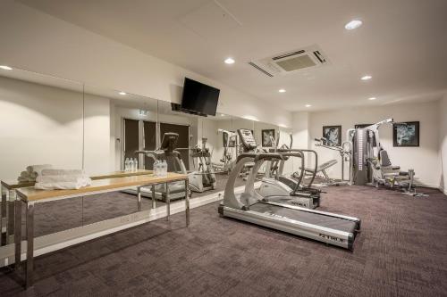 a gym with a treadmill and elliptical machines at Quest King William South in Adelaide