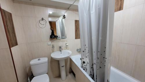 a bathroom with a toilet and a sink and a shower at Квартира около мед центра Астхик in Yerevan