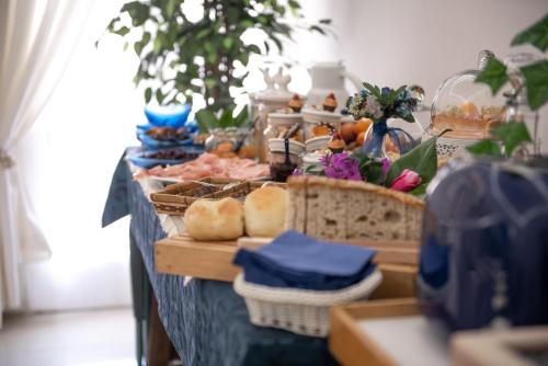 a table with bread and other food on it at B&B Toma Street in Lecce