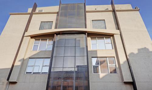 a tall building with windows on the side of it at Treebo Elite City Upper Bazar in Rānchī
