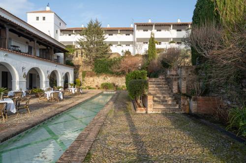 a resort with a swimming pool and a building at Parador de Guadalupe in Guadalupe