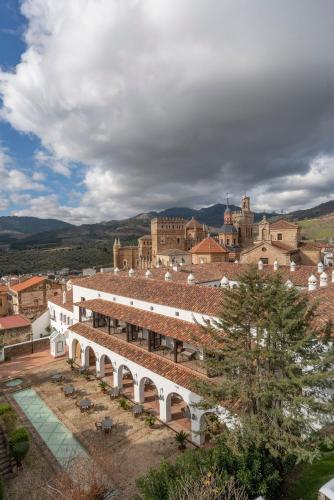 a large white building with a city in the background at Parador de Guadalupe in Guadalupe