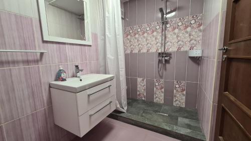 a bathroom with a sink and a shower at Focalize Apartament in Buzău