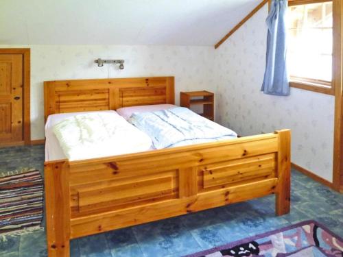 a bedroom with a wooden bed in a room at Apartment STRYN in Stryn