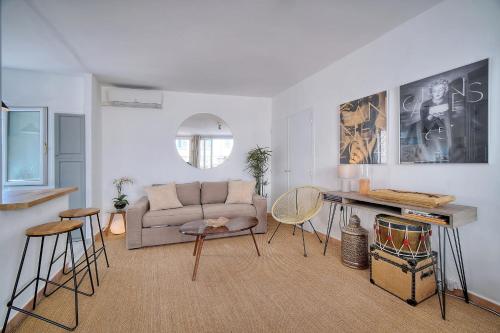 a living room with a couch and a table and chairs at IMMOGROOM - Splendid Terrace - Studio - Central in Cannes