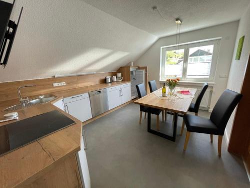 a kitchen with a table and chairs and a dining room at Weingut & Straußwirtschaft Vogel in Vogtsburg