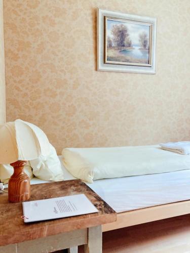 a bed with a table with a laptop on it at Hotel Gletscherblick in Hasliberg