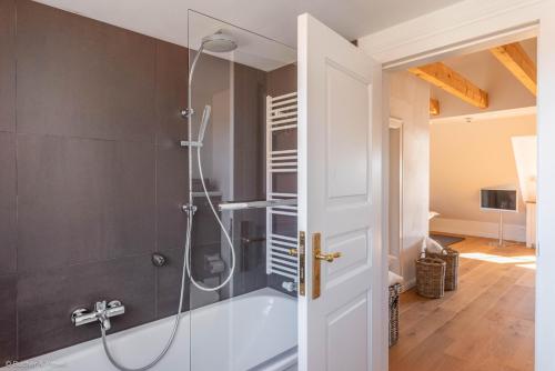 a bathroom with a shower with a glass door at HofGut Bockelkathen Apartment 4 in Lüdersburg