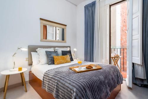 a bedroom with a bed with a tray on it at Whisper-quiet Near Sagrada's Heart in Barcelona
