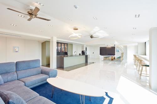 a living room with a couch and a table at Elren Hotel Jeju in Seogwipo