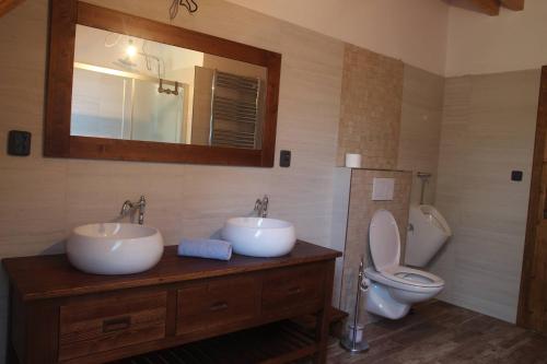 a bathroom with two sinks and a toilet at Roubenka U Zvoničky in Cejle