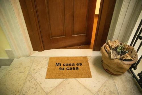 a sign sitting on the floor in front of a door at Palazzo de Brado in Trani