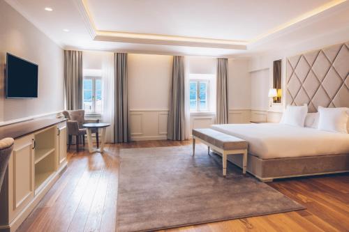 a hotel room with a bed and a desk at Heritage Grand Perast By Rixos in Perast