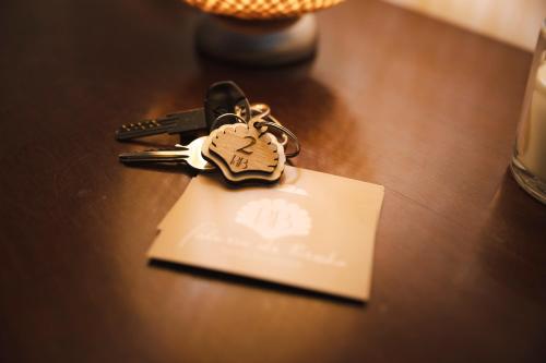 a bunch of keys on top of a table at Palazzo de Brado in Trani