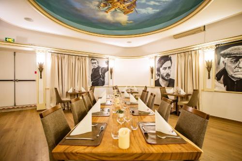 a dining room with a large table and chairs at Hotel Les Tourelles in Sainte-Maxime