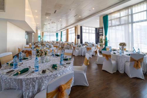 a banquet hall with white tables and chairs at PrideInn Azure Hotel Nairobi Westlands in Nairobi