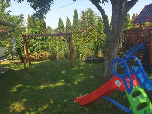 a pair of scissors sitting next to a tree at Famvarga Apartmanház in Balatonfenyves