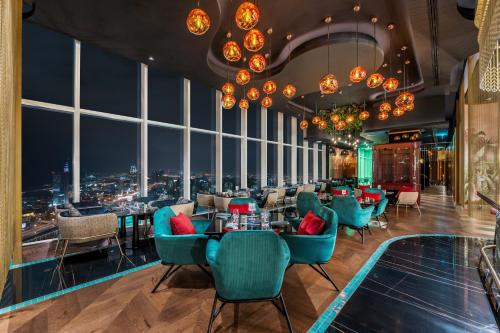 a dining room filled with tables and chairs at Taj Jumeirah Lakes Towers in Dubai