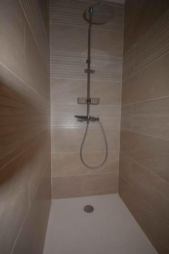 a shower with a shower head in a bathroom at Chambres 2 caps in Ambleteuse