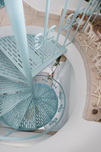 a spiral staircase in a building with a glass ceiling at Dream House Efi in Ravdhoúkha