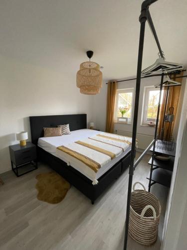 a bedroom with a large bed with a black frame at Fehmarntraum in Fehmarn