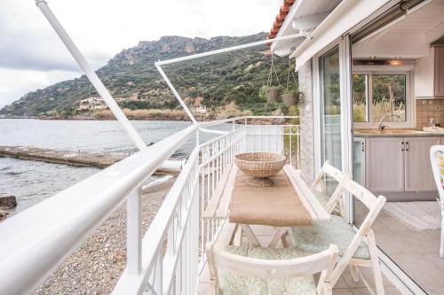 a balcony with a table and chairs on a boat at Dream House Efi in Ravdhoúkha
