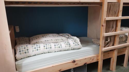 a bunk bed in a bunk bed room with a bedsheet at Heart of Glencoe Holidays in Glencoe
