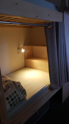 a bunk bed with a light on top of it at Heart of Glencoe Holidays in Glencoe