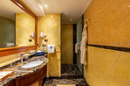 a bathroom with a sink and a mirror at Swiss Diamond Hotel Prishtina in Pristina